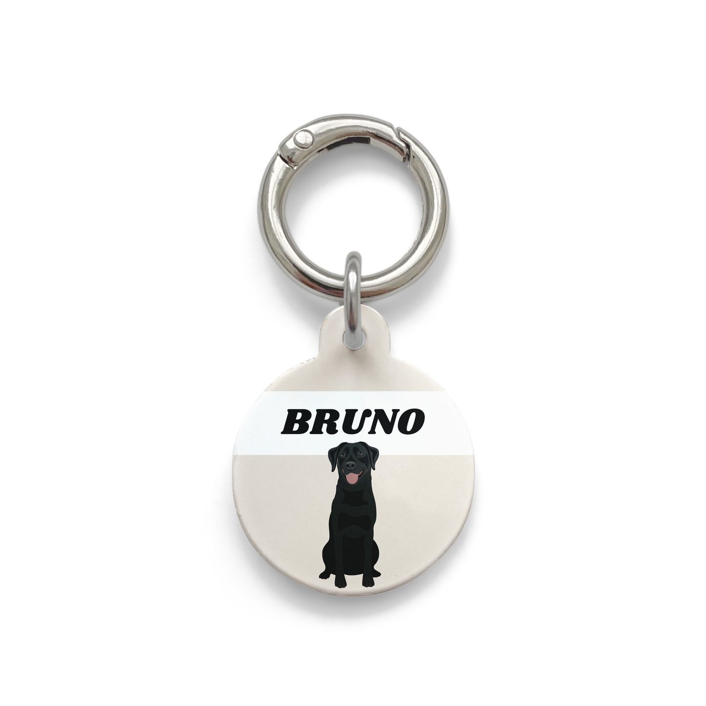 Black Labrador illustration on a circular dog ID tag with a beige background and silver ring.