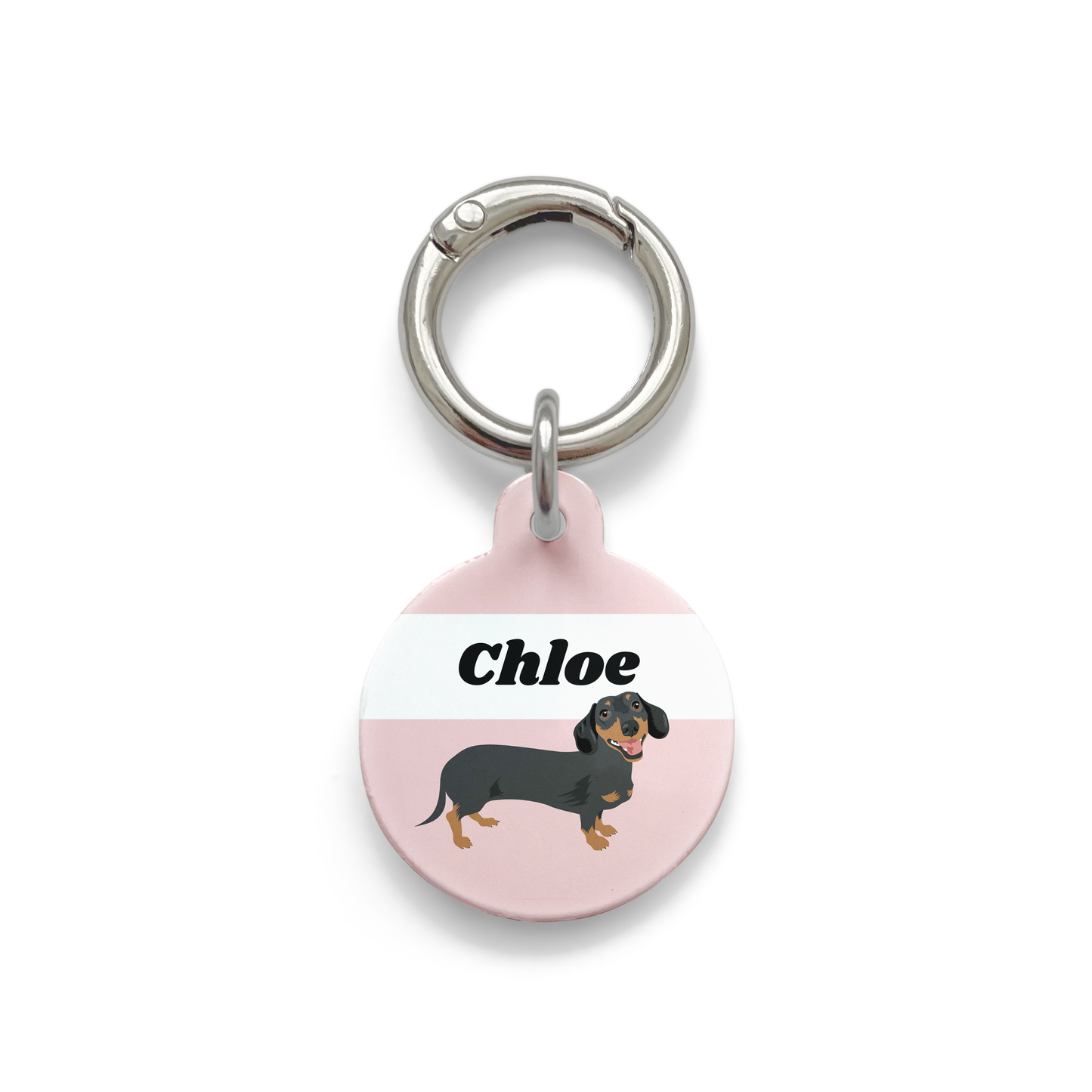Black and tan dachshund illustration on a circular dog tag with a pink background and silver ring.