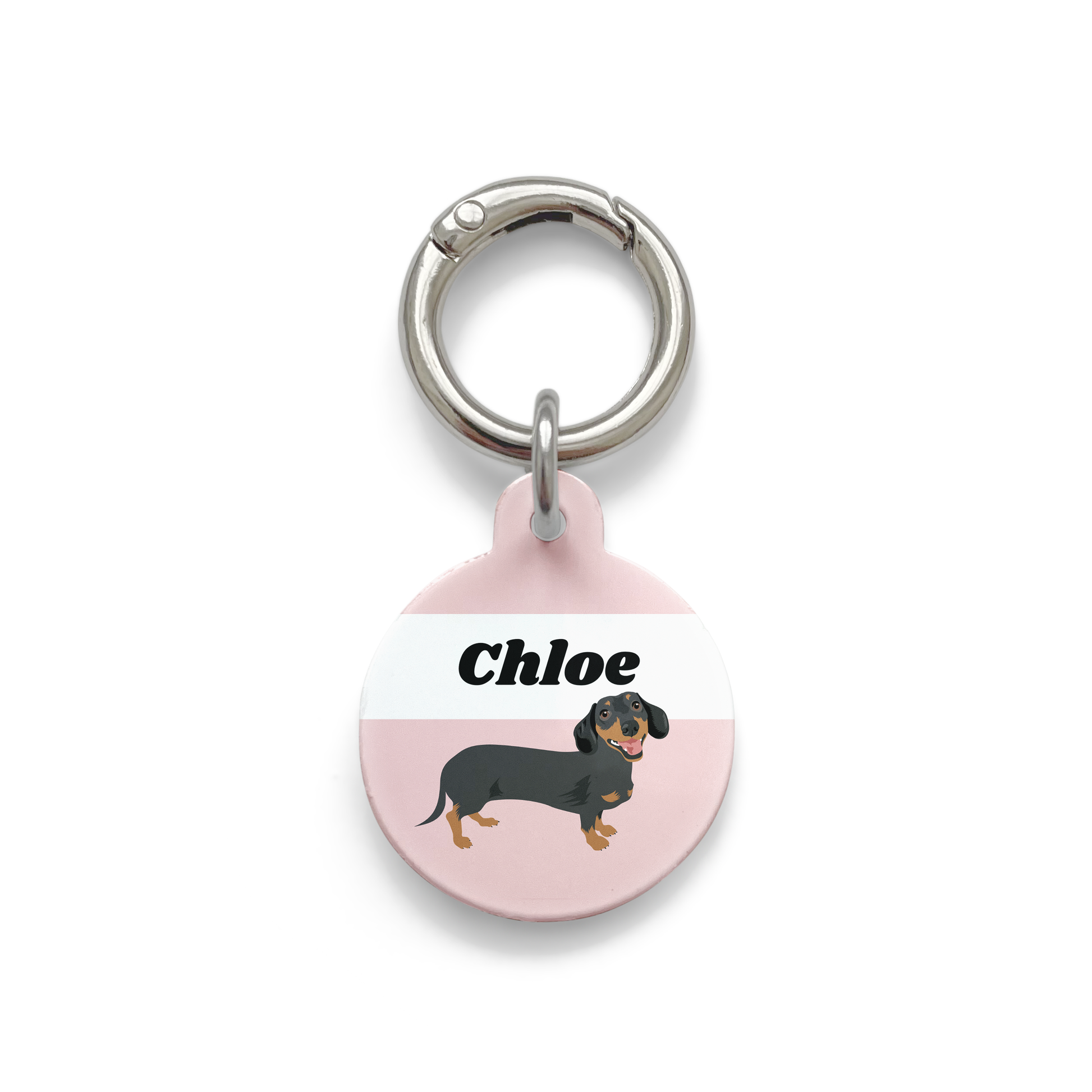 Black and tan dachshund illustration on a circular dog tag with a pink background and silver ring.
