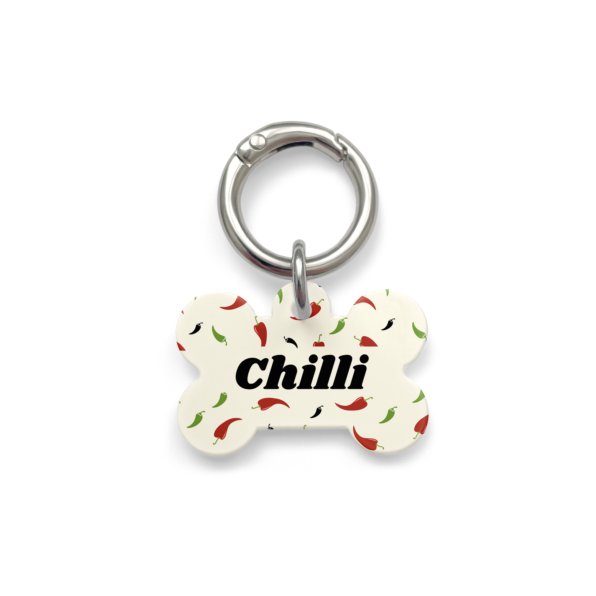Custom pet ID tag with a design showing green red and black chillies on a bone shaped beige background with silver ring.