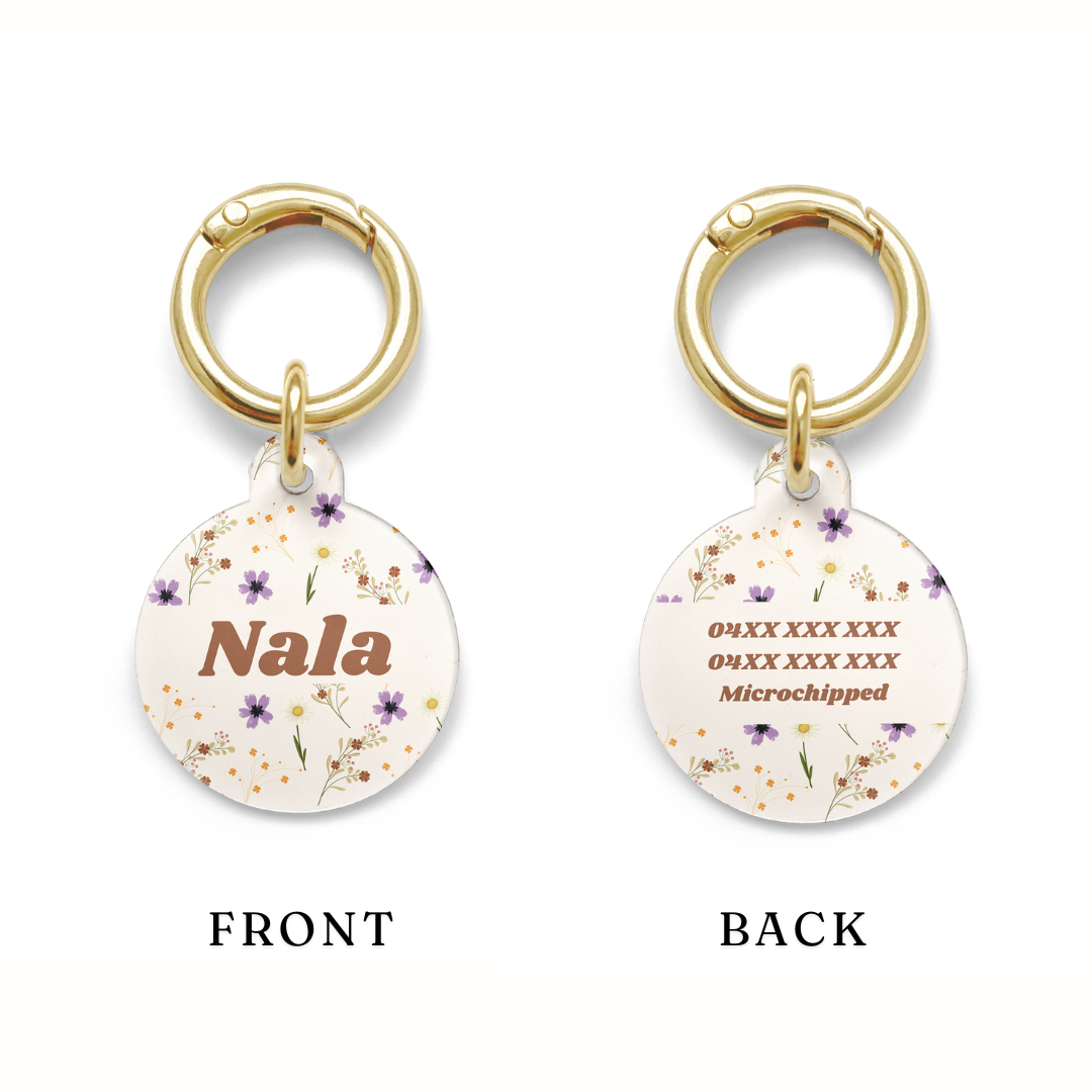 Example of the positioning of the contact details on a Floral pet ID tag with a design showing a range of purple, yellow and orange flowers on a beige background with gold ring.
