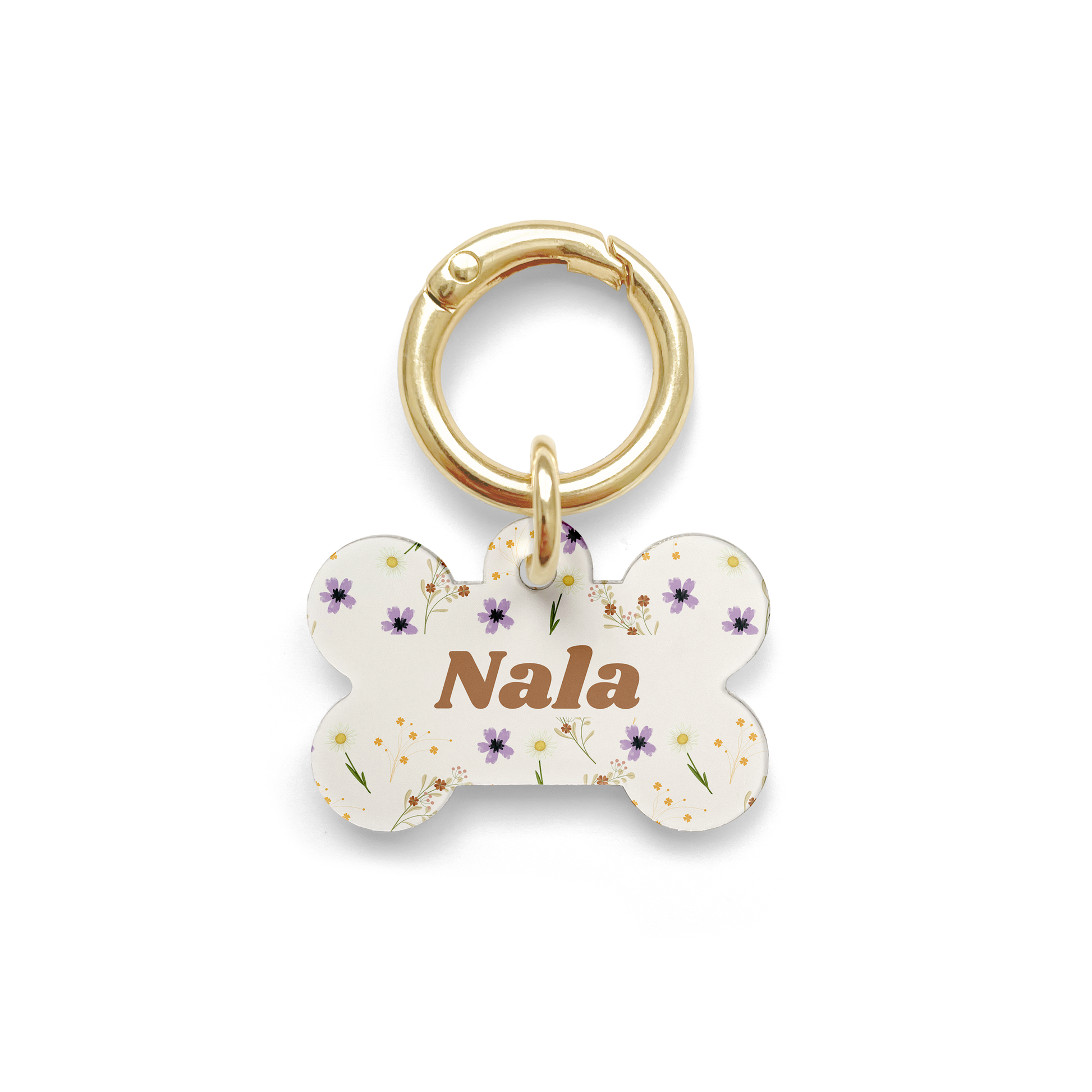 Floral pet ID tag with a design showing a range of purple, yellow and orange flowers on a bone shaped beige background with gold ring.