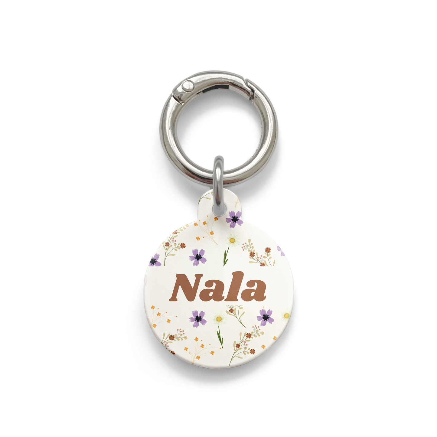 Floral pet ID tag with a design showing a range of purple, yellow and orange flowers on a beige background with silver ring.