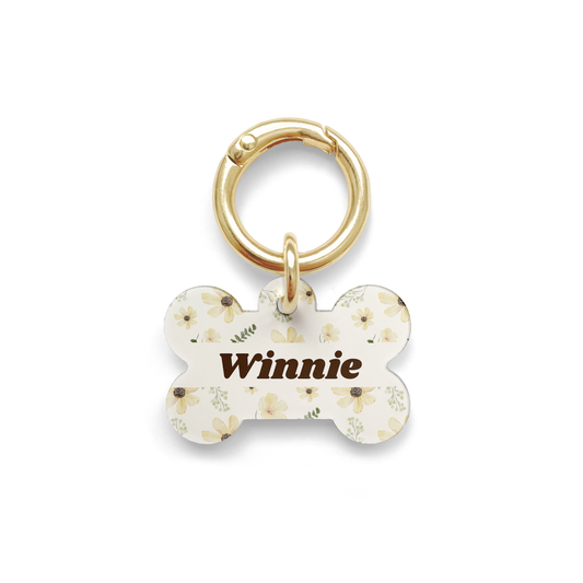 Floral sunflower design on a bone shaped pet ID tag with a gold ring.