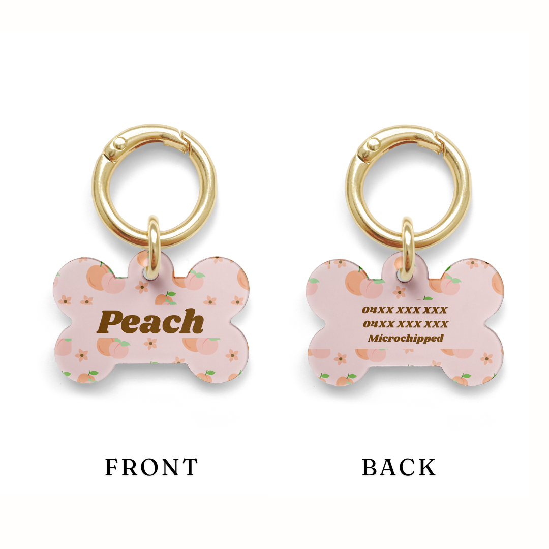 Example of the contact detail positioning on a Peach styled Pet ID tag in a bone shape with a gold ring. 