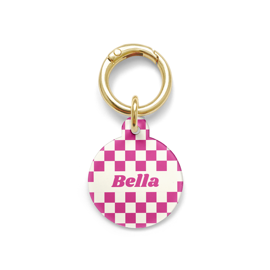 Pink and white checker styled Pet ID tag in a circular shape with a gold ring. 