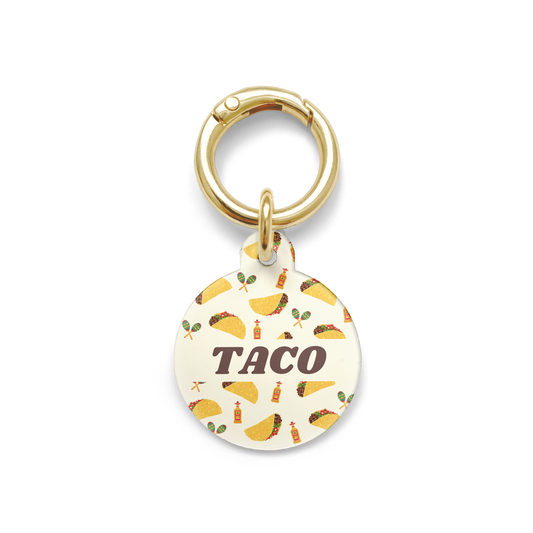 Circle shaped pet ID tag with a design showing tacos, tequila and  maraca's with gold ring.